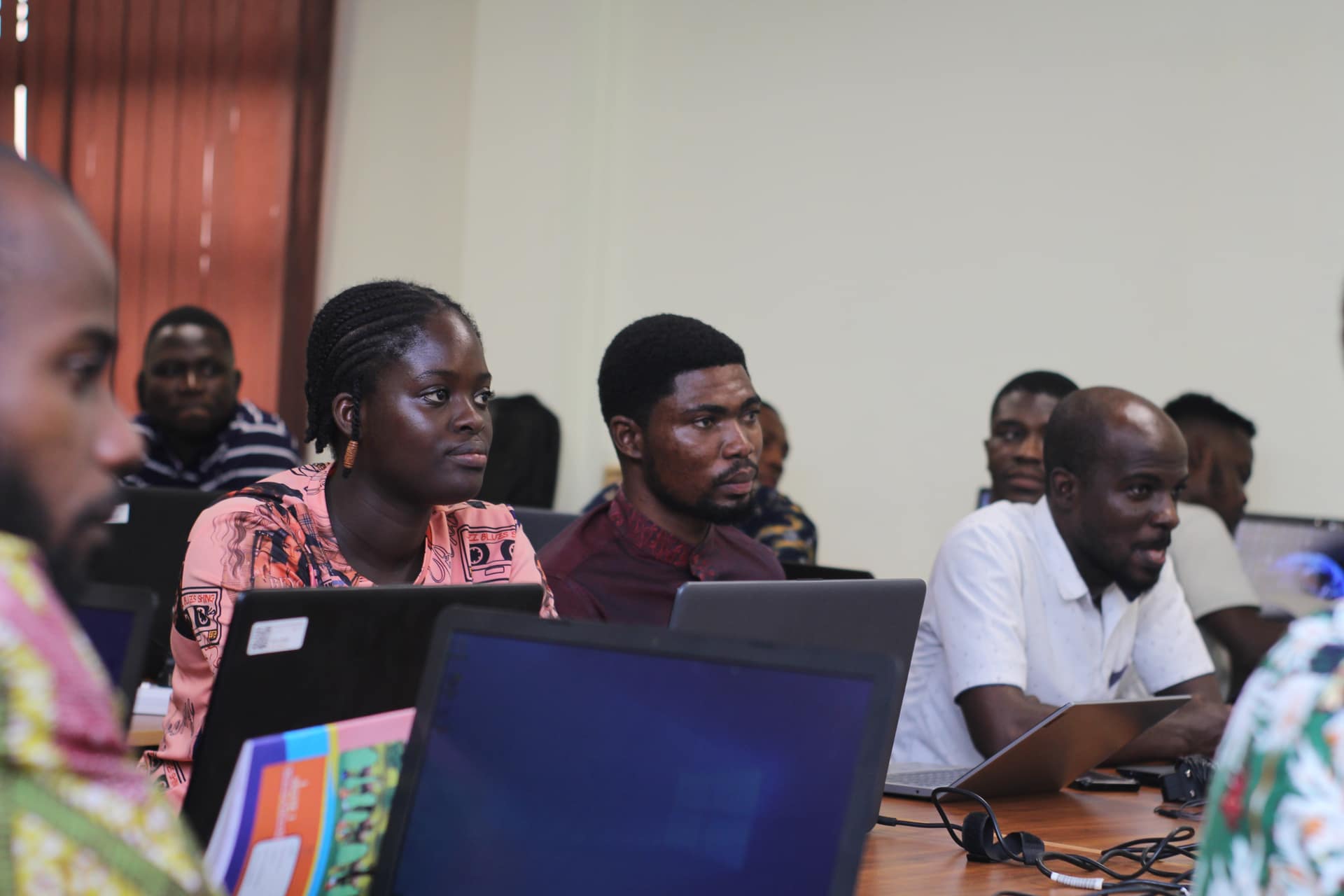Young Ghanaian learners working on laptops in a hands-on Digital Futures session